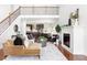 Open floor plan with a living room featuring a fireplace, staircase, and view of the kitchen at 360 Beracah Sw Trl, Atlanta, GA 30331