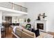 Inviting living room features a staircase, fireplace, view to kitchen and stylish decor at 360 Beracah Sw Trl, Atlanta, GA 30331