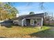 The back exterior of the home shows the covered patio and fenced back yard at 4657 Tartan Ct, Union City, GA 30291