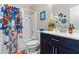 Bathroom featuring modern vanity, butterfly shower curtain and tub with shower at 4657 Tartan Ct, Union City, GA 30291