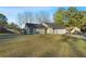 Exterior view of this lovely property from the side showing a large lawn and mature trees at 4657 Tartan Ct, Union City, GA 30291