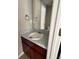 Half bathroom features a vanity with a unique tiled countertop and matching mirror at 8302 N Sterling Lakes Dr, Covington, GA 30014