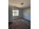 Bedroom with natural light from the window and a view of a lush yard, creating a calm and airy space at 8302 N Sterling Lakes Dr, Covington, GA 30014