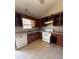 Kitchen with open cabinets, white appliances, and patterned backsplash at 8302 N Sterling Lakes Dr, Covington, GA 30014