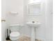 Neat bathroom with a pedestal sink, a white toilet, and neutral-toned flooring at 1688 Jackson Sq, Atlanta, GA 30318