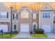 Attractive townhome featuring brick and neutral siding, with well-maintained landscaping at 1688 Jackson Sq, Atlanta, GA 30318