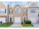 Charming townhome featuring a brick front, attached garage and well-manicured landscaping at 1688 Jackson Sq, Atlanta, GA 30318