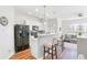 Bright kitchen with stainless steel appliances, breakfast bar, and a view to the living room at 1688 Jackson Sq, Atlanta, GA 30318