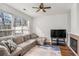 Bright living room with a comfortable sectional sofa, fireplace, and large windows offering natural light at 1688 Jackson Sq, Atlanta, GA 30318