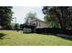 The backyard is spacious with a green lawn and an appealing elevated deck at 1770 Bethany Spring, Cumming, GA 30041