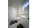Cozy bathroom with combination shower and tub, single vanity and white tile floor at 1770 Bethany Spring, Cumming, GA 30041