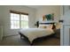 Cozy bedroom with neutral decor, window views, and a side table with lamp at 1770 Bethany Spring, Cumming, GA 30041
