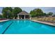 Community pool with inviting blue water, lounge chairs, and shaded seating area at 1770 Bethany Spring, Cumming, GA 30041