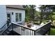 Enjoy this deck's stylish chairs and fire pit set with a backyard view at 1770 Bethany Spring, Cumming, GA 30041