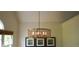 Stylish chandelier hangs above artwork in the dining room with neutral walls and natural lighting at 1770 Bethany Spring, Cumming, GA 30041