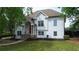 Elegant two story home with a white facade, complemented by a manicured lawn and classic architectural details at 1770 Bethany Spring, Cumming, GA 30041