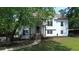 Inviting two-story home with well-manicured lawn and a charming exterior, framed by mature trees and a stone foundation at 1770 Bethany Spring, Cumming, GA 30041