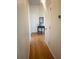 Hallway with hardwood floors, white trim, and a decorative table at 1770 Bethany Spring, Cumming, GA 30041