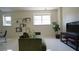 Bright living room features a comfortable green couch, shelving, and a black TV stand and TV at 1770 Bethany Spring, Cumming, GA 30041