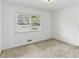 Bedroom featuring wood paneling, carpet, and a window for natural light at 1911 Lavista Ne Rd, Atlanta, GA 30329