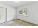 Bedroom featuring wood paneling, carpet, closet, and a window for natural light at 1911 Lavista Ne Rd, Atlanta, GA 30329