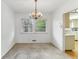 Dining room with chandelier, beige walls and carpet, window view to the back yard at 1911 Lavista Ne Rd, Atlanta, GA 30329