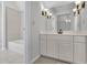Bright bathroom with a tub and a vanity featuring framed mirror and decorative sconces at 5004 Barnwood Nw Ter, Kennesaw, GA 30152