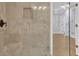 Shower with a bench, stone walls, and glass doors, and views into the bedroom at 5004 Barnwood Nw Ter, Kennesaw, GA 30152