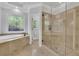 Beautiful bathroom featuring a soaking tub, a shower, and stylish stained glass windows at 5004 Barnwood Nw Ter, Kennesaw, GA 30152