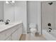 Bathroom with a white vanity, neutral flooring, toilet and a bathtub with shower at 5004 Barnwood Nw Ter, Kennesaw, GA 30152