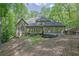The rear of the home has an outdoor deck and many windows with a wooded backyard at 5004 Barnwood Nw Ter, Kennesaw, GA 30152