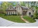 Home exterior showing a manicured lawn, and a stone staircase leading to the arched entryway at 5004 Barnwood Nw Ter, Kennesaw, GA 30152