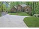 Inviting home featuring a well manicured lawn, complemented by a long drive way, and surrounded by lush trees at 5004 Barnwood Nw Ter, Kennesaw, GA 30152