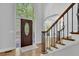 Elegant foyer featuring hardwood floors, staircase with decorative iron railings, and sidelight windows at 5004 Barnwood Nw Ter, Kennesaw, GA 30152