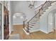 Elegant foyer with hardwood floors, stairway with black iron railings, and entry to dining room at 5004 Barnwood Nw Ter, Kennesaw, GA 30152