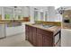 Gourmet kitchen features a central island with a cooktop and dark wood cabinets at 5004 Barnwood Nw Ter, Kennesaw, GA 30152