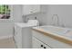 Practical laundry room with washer, dryer, sink, and storage cabinets at 5004 Barnwood Nw Ter, Kennesaw, GA 30152