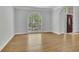 Bright living room showcasing hardwood floors, arched window, and neutral wall color at 5004 Barnwood Nw Ter, Kennesaw, GA 30152