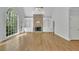 Sunlit living room with hardwood floors and a stone fireplace flanked by built-in shelving at 5004 Barnwood Nw Ter, Kennesaw, GA 30152