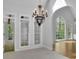 Bright living room featuring arched windows, high ceilings, and tiled floors at 5004 Barnwood Nw Ter, Kennesaw, GA 30152