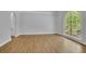 Bright living room showcasing hardwood floors, large arch window, and neutral wall color at 5004 Barnwood Nw Ter, Kennesaw, GA 30152