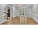 Spacious living room featuring an archway entrance, a bay window, and beautiful hardwood floors at 5004 Barnwood Nw Ter, Kennesaw, GA 30152