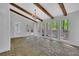 Bright sunroom with brick flooring, wooden beams, chandelier, and nature views through large windows at 5004 Barnwood Nw Ter, Kennesaw, GA 30152