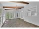 Spacious sunroom with brick flooring, beamed ceilings, chandelier, and large windows offering natural light at 5004 Barnwood Nw Ter, Kennesaw, GA 30152