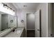 Bright bathroom featuring a granite-topped vanity and modern light fixture at 600 Bedfort Dr, Duluth, GA 30096