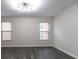 Light filled room with two windows, recessed lighting, and luxury vinyl plank flooring at 600 Bedfort Dr, Duluth, GA 30096