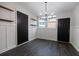 Dining room with paneling, modern light fixtures, and wood floors at 600 Bedfort Dr, Duluth, GA 30096