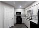 Modern kitchen with white cabinets, stone countertops and black appliances at 600 Bedfort Dr, Duluth, GA 30096