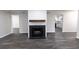Spacious living room with wood floors, fireplace, and views into the kitchen at 600 Bedfort Dr, Duluth, GA 30096