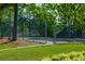 Community tennis court surrounded by lush greenery at 600 Bedfort Dr, Duluth, GA 30096